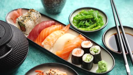 Asian-food-assortment--Various-sushi-rolls-placed-on-ceramic-plates