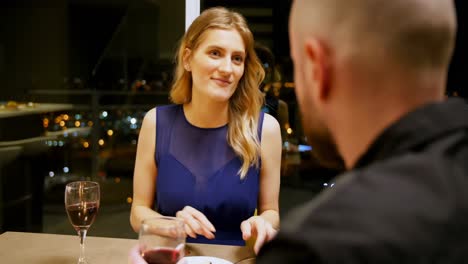 couple toasting glass of wine while having dinner 4k