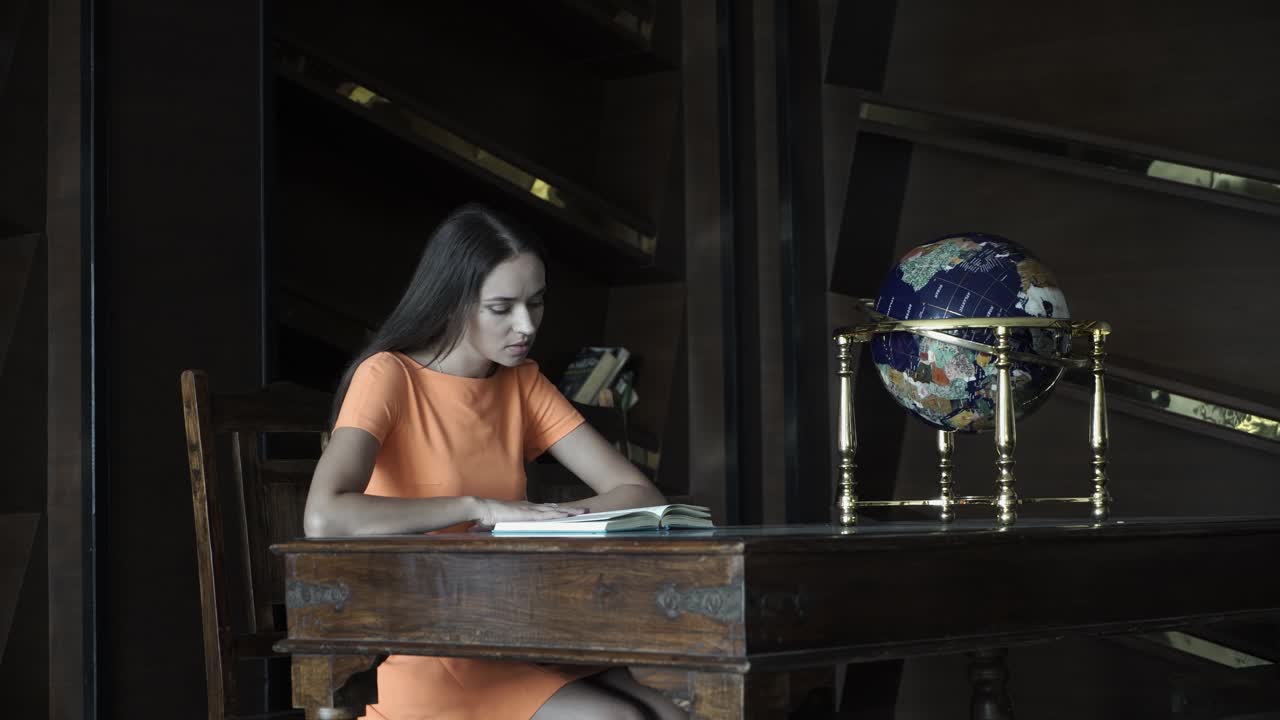 Woman Reading a Book in a Library