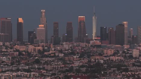rising telephoto aerial shot of downtown los angeles at sunset in southern california. 4k