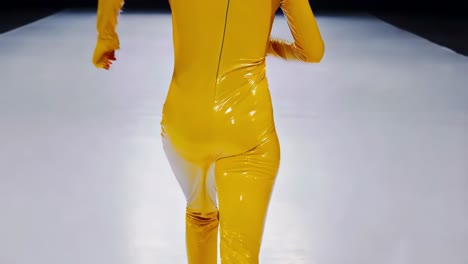 fashion show model in yellow catsuit