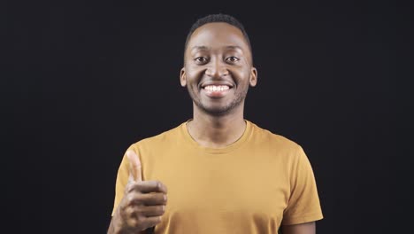 Stylish-and-attractive-african-young-man-looking-at-camera-and-giving-check-mark.