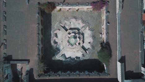 drone aerial bird's eye view of a beautiful colonial style fountain located in antigua guatemala