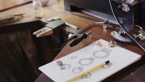 close up of handcraft tools and design in jewellery studio in slow motion