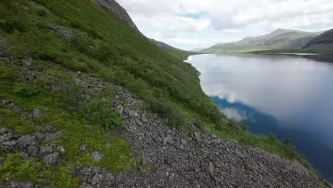 A-thrilling-FPV-flight-over-mountain-lakes-amidst-a-backdrop-of-majestic-peaks,-an-immersive-journey-into-the-heart-of-alpine-splendor