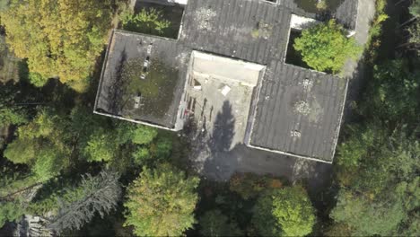 aerial view of an abandoned building surrounded by forest