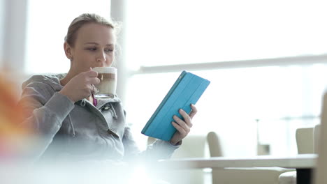 Woman-in-cafe-using-her-touchpad