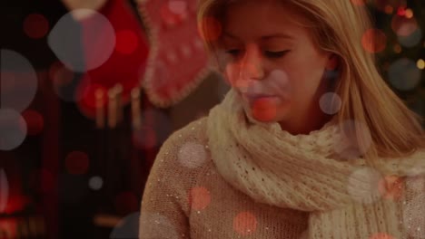 Animation-of-christmas-flickering-lights-over-woman-drinking-wine