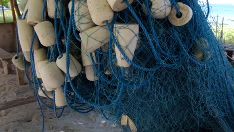 a traditional beach bamboo shack with handmade fishing nets and floats in a local community on a remote tropical island