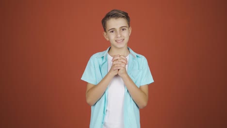 boy looking at camera making confidence sign.