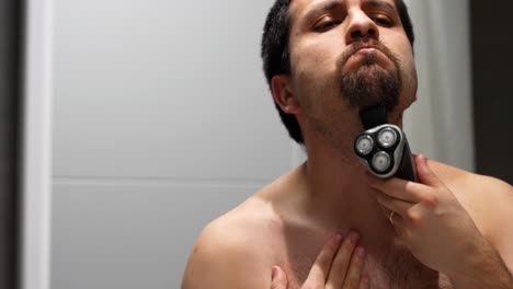 man shaving to get a goatee and mustache in the bathroom