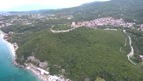 Aerial-view-of-castle-on-the-top-of-the-hill,-down-the-ocean-