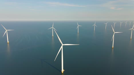 huge windmill turbines, offshore windmill farm in the ocean westermeerwind park , windmills isolated at sea on a beautiful bright day netherlands flevoland noordoostpolder