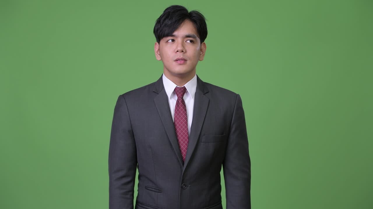 젊은 잘생긴 아시아 사업가 지루해 보이네요