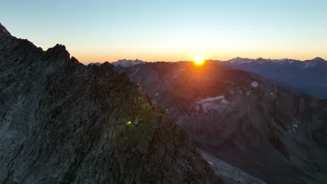 mountain peak with a cross at sunrise. drone footage in the alps.