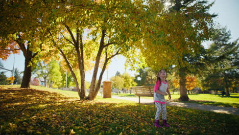 girl playing in an autumn park