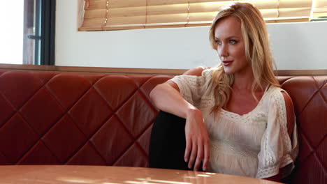 woman sitting on sofa in restaurant 4k