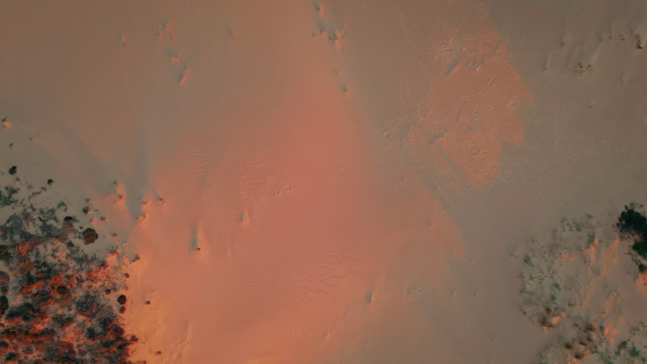 Aerial view sunset dunes in wilderness. Tranquil desert landscape on golden hour