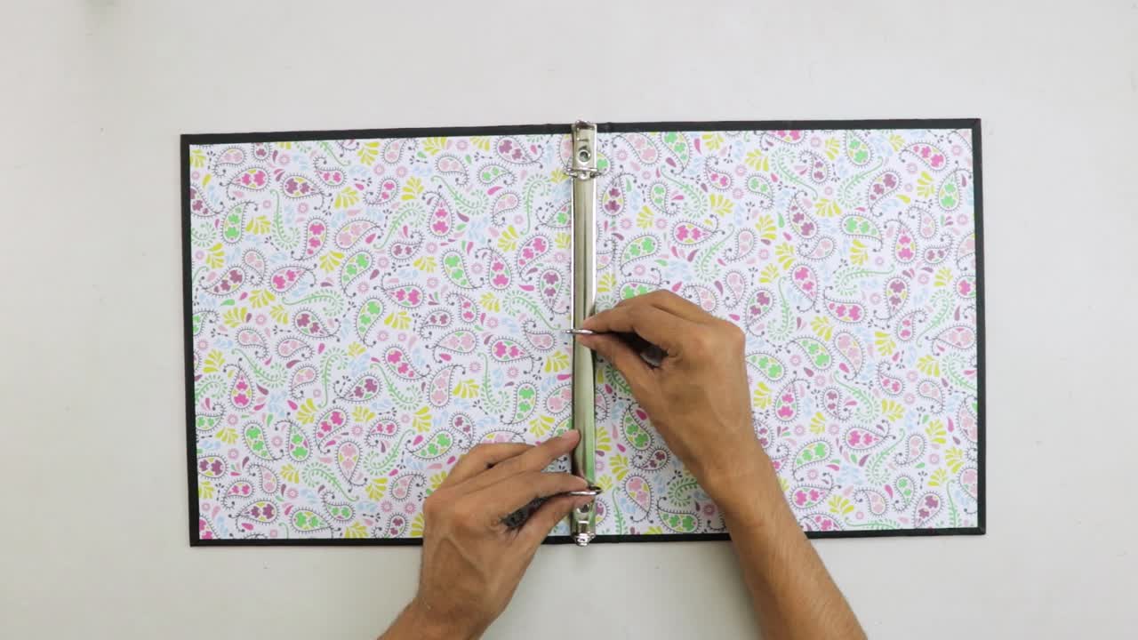 Placing metal ring spine binder inside decorated lever arch file