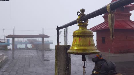 misty temple with golden bell in nepal