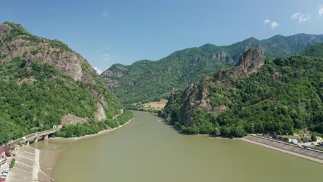 aerial shot of olt river flowing through the scenic cozia mountains, lush greenery surrounding