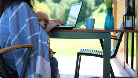 young freelancer woman working at the computer in a mountain chalet.