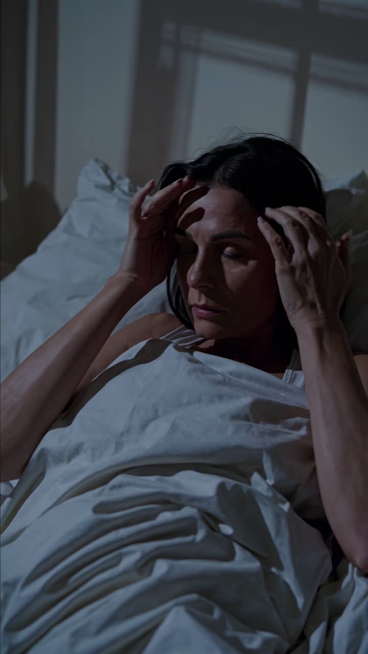 A dimly lit video scene shows a person asleep in bed at 3:00 AM