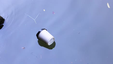 plastic cup drifting in water near floating market