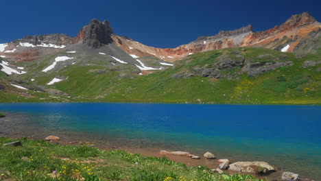 Colorado-Ice-Lake-Basin-trailhead-lower-stunning-bright-blue-alpine-clear-water-summer-blue-sky-Rocky-Mountain-snow-range-peaks-Silverton-Telluride-dreamy-peaceful-wildflowers-wind-slow-still-movement