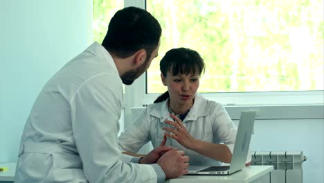 young doctors working with a laptop in an office