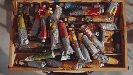 paint tubes in wooden case in art studio