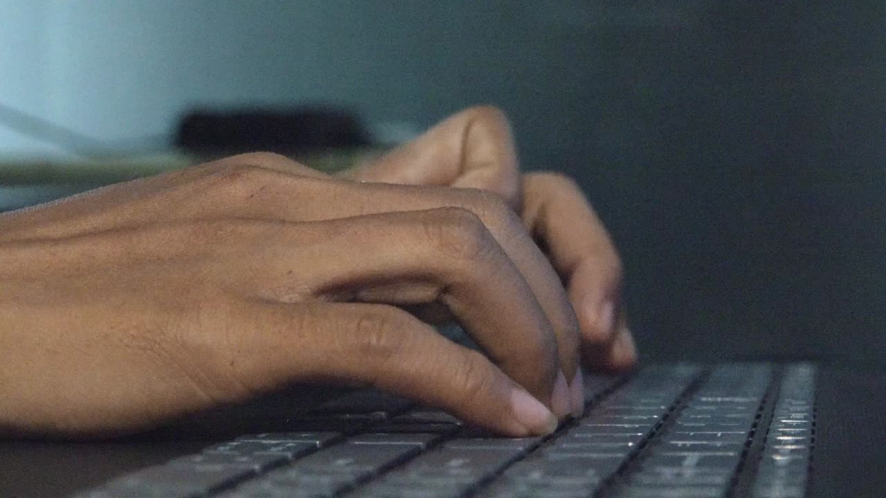 Low Close Shot of Female Hands Typing on a Laptop Computer