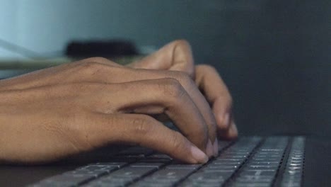 low close shot of female hands typing on a laptop computer