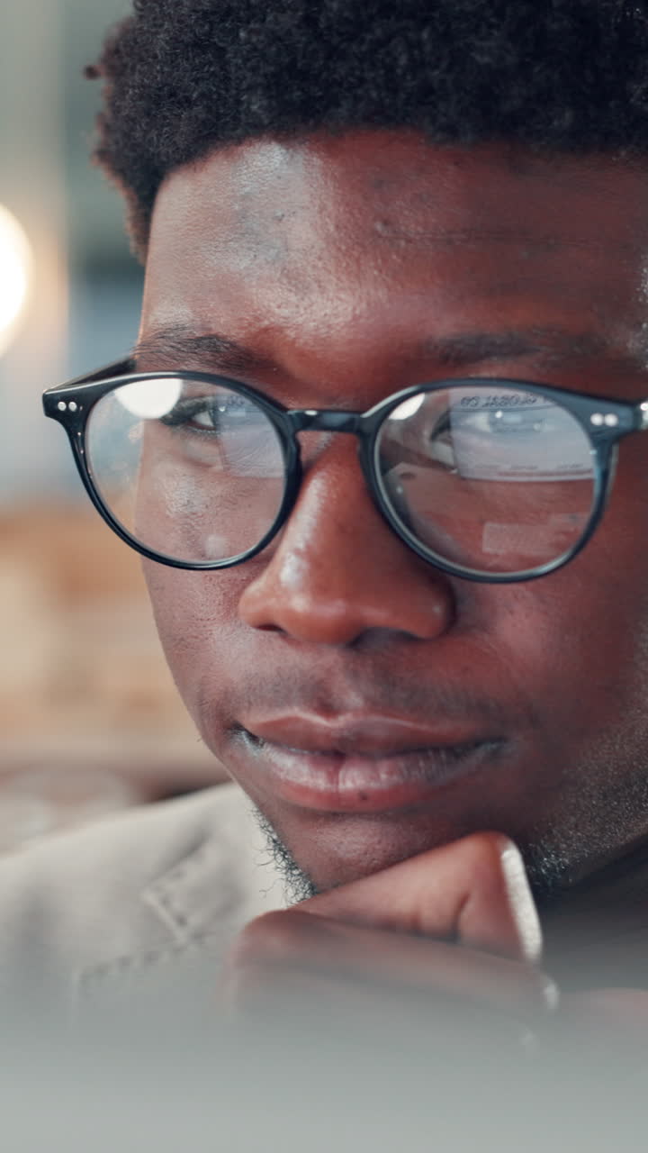 Close-up of Focused Young Black Man in Glasses Looking at Screen
