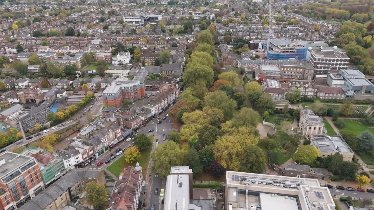Aerial orbital view of Ealing Green, showing a mix of historic buildings, residential housing, and green spaces, capturing the community’s charm and architecture in Ealing, London, UK