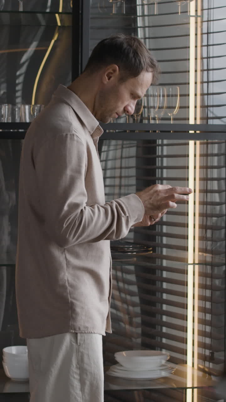 Man using a phone in the kitchen