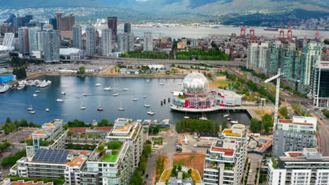 panorama of false creek with science world, bc place and downtown vancouver in bc, canada