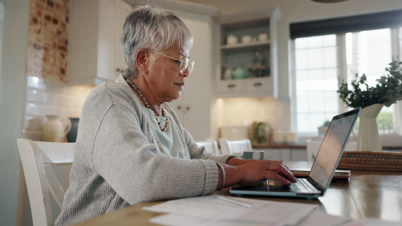 Senior woman, documents and laptop for bills