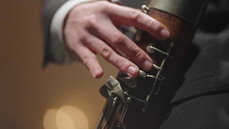 musician is playing bassoon closeup view of hands pressing holes by fingers classic music instrument