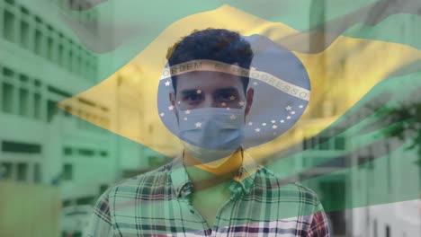 Animation-of-flag-of-brazil-waving-over-latin-man-wearing-face-mask