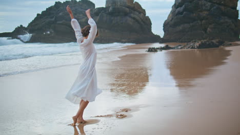 joyful woman enjoying beach at ocean cliffs. happy carefree lady walking shore