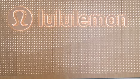 shoppers walk past the canadian sportswear brand lululemon store at a shopping mall in hong kong.