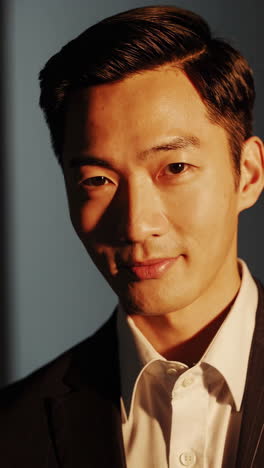 portraits of an asian man in a suit