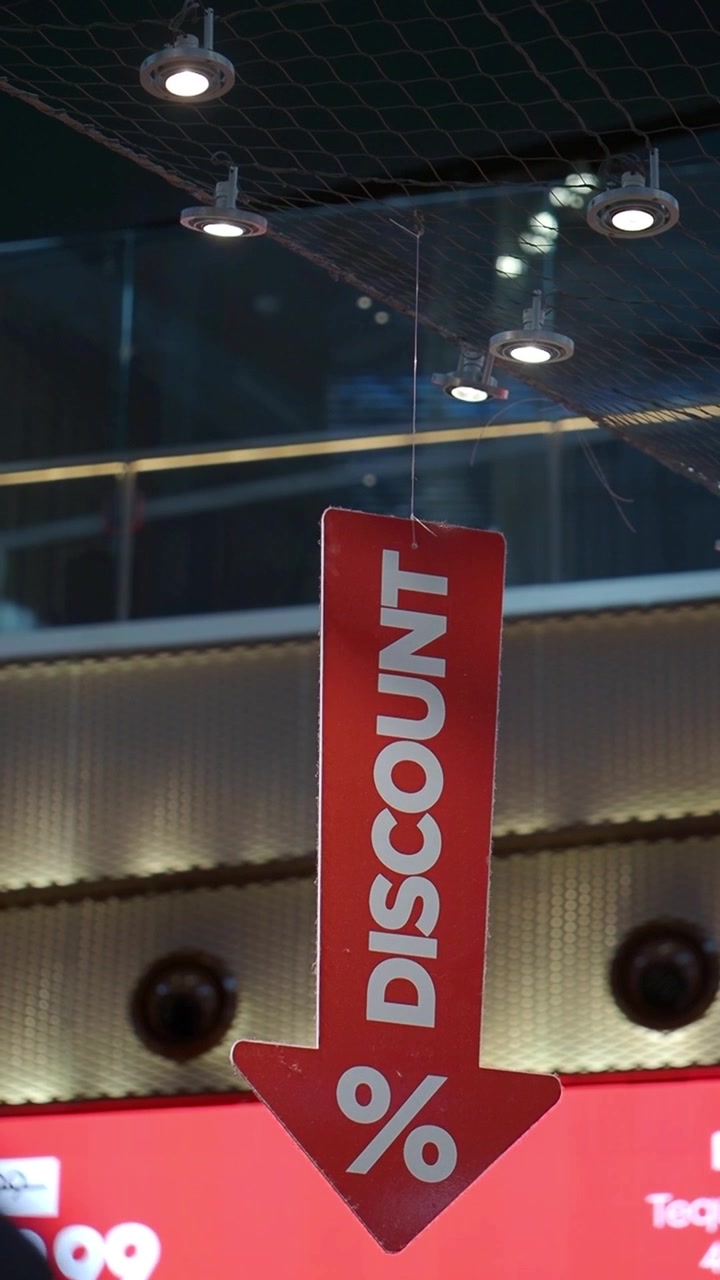 Red Discount Sign Hanging in a Shopping Mall