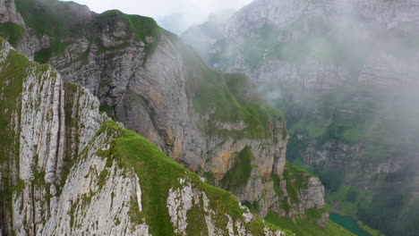 cinematic drone shot starting on a mountain ridge then revealing altenalp turm in switzerland