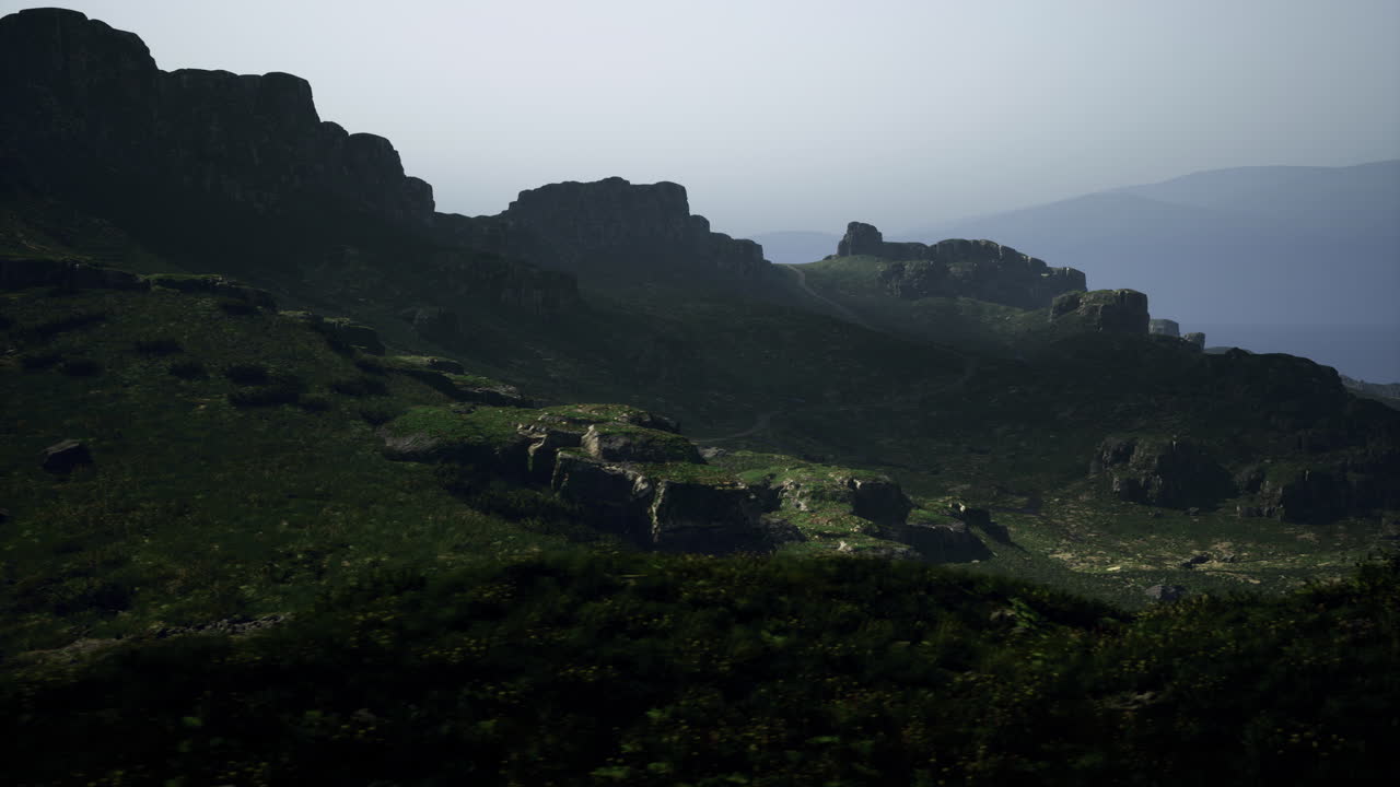 Scenic view of mountains under misty sky during early morning light