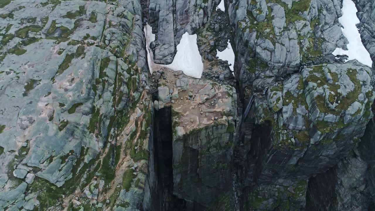Scenic drone shot of Kjerag cliffs and fjord canyon, rugged textures, 4K, Norway