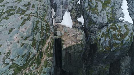 scenic drone shot of kjerag cliffs and fjord canyon, rugged textures, 4k, norway