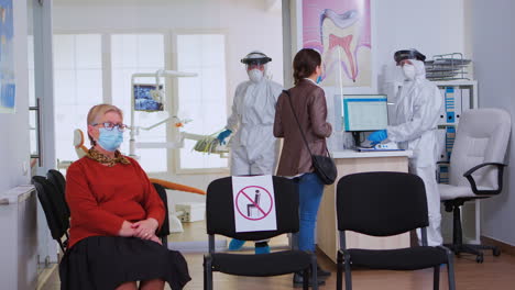 dental doctor in protective suit working in busy stomatological clinic