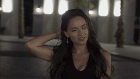 beautiful girl in the background of a night city in slow motion